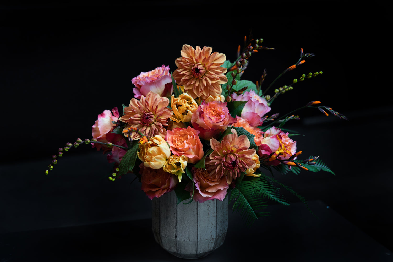 This unique arrangement of flowers will form a most pleasant gift for different occasions, may be used as a center piece at a dinner or just to decorate. The clever arrangements of the orange and yellow dahlias, roses and carnations is attractive